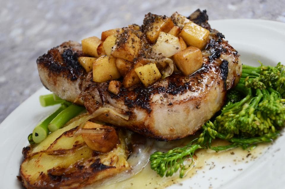 Seared pork loin with caramelized apples, broccolini, and roasted potatoes
